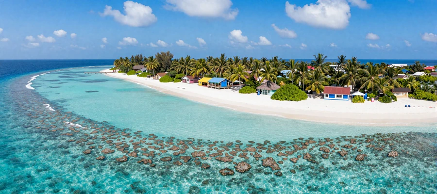 Scenic Maldives atoll with turquoise lagoon and local island representing the natural beauty of Maldivian island life